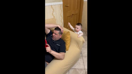 Surprise ladle attack: toddler's playful gesture takes grandfather by surprise!