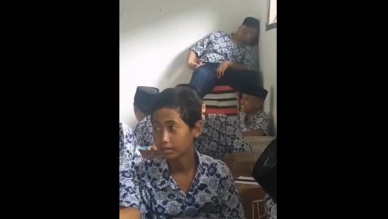 Student falls asleep during lesson in classroom in Indonesia