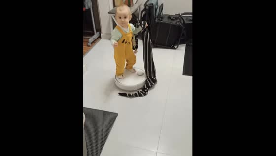 Toddler’s joyride: spinning on a robot vacuum in Moscow, Russia