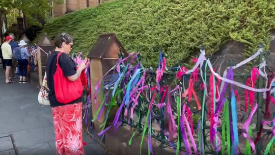 Victims and survivors of clergy abuse tie a ribbon in front of St. Mary's Cathedral in Sydney
