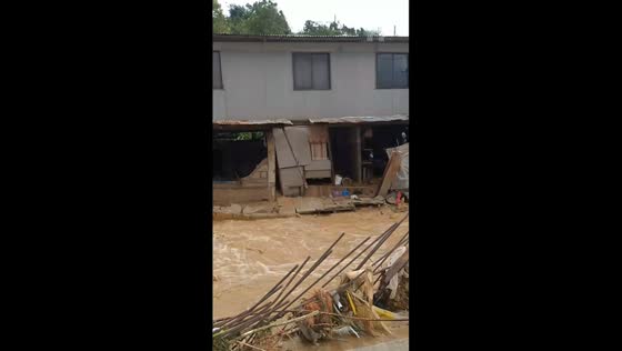 Eroding house begins sliding as floodwaters rage in Consolacion, Cebu, Philippines