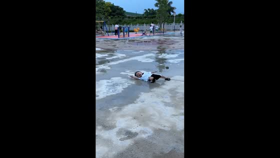Boy slips on wet ground at playground in Guangdong, China