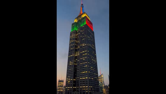 Empire State Building glows in vibrant lights at dusk in New York, USA