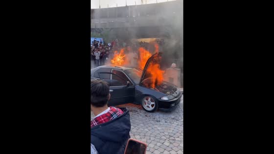Karachi car fire: person retrieves items amid blaze