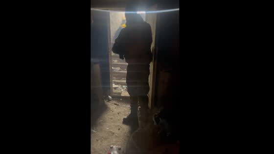 Ukrainian soldiers share a laugh amidst Russian firefight
