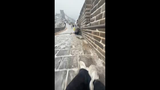 Visitors struggle to walk on slippery Great Wall path during icy weather in Beijing, China