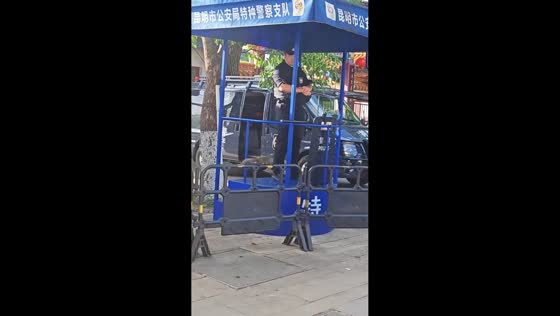 Police officer feeds squirrel at outpost in Yunnan, China