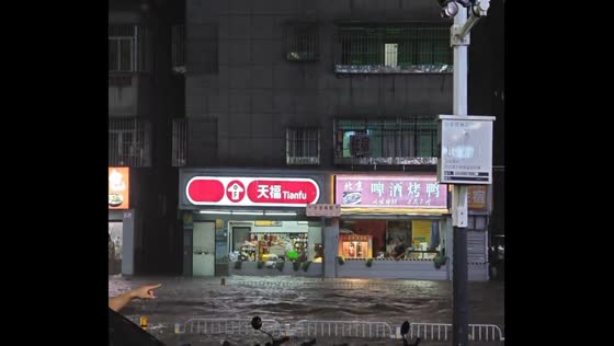 Residents clear floodwater after street flooding in Shenzhen, China