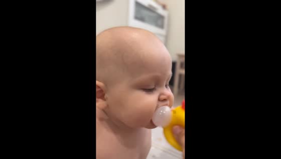 Baby plays with toy chicken in Krasnodar, Russia