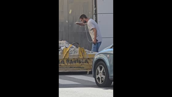 Man snorts cement from rubble in Seville, Spain