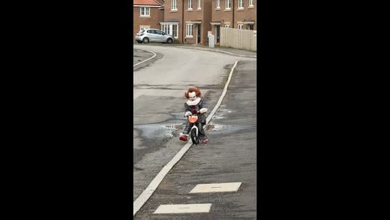 Child dressed as Pennywise rides bike for Halloween in Middlesbrough, UK