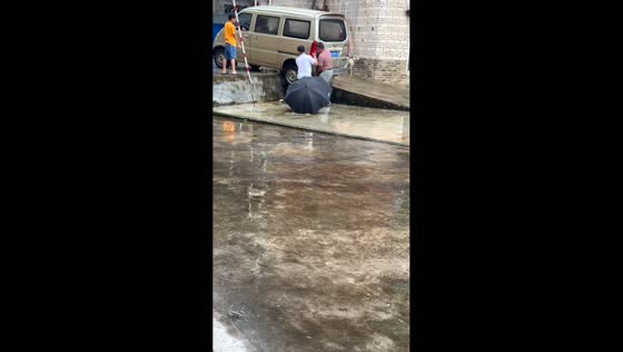 Dog falls from wet concrete ramp while watching people in Guangdong, China