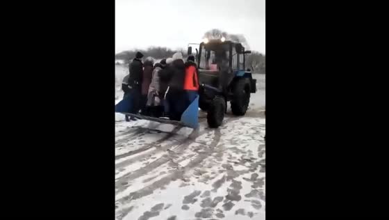 Riding in a tractor bucket: the scary yet ingenious way to cross a flooded river in Penza, Russia