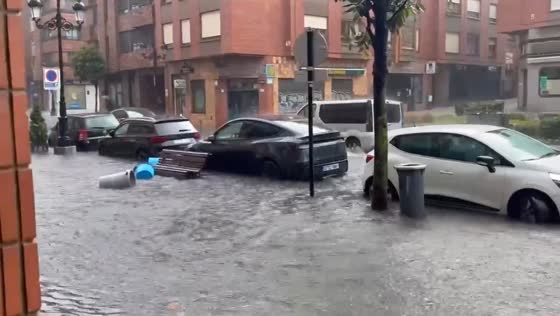 Severe flooding submerges residential street during heavy rain in Oviedo, Spain
