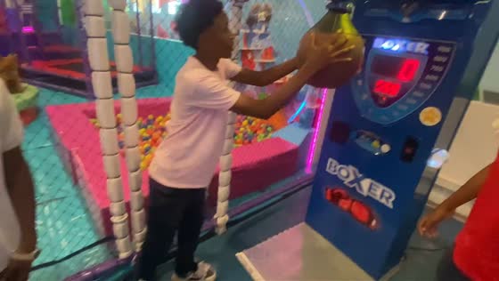 Men tumble while trying punching machine in Santa Marta, Colombia