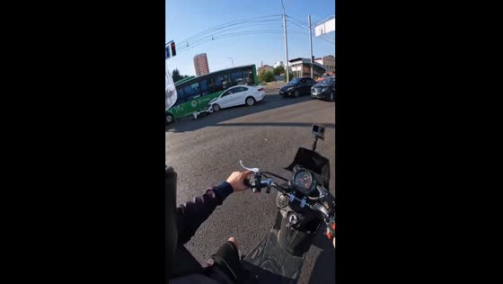 Driver cuts off motorcyclist, crashes into bus in Almaty, Kazakhstan