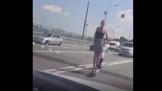 Woman and child embark on a dangerous scooter ride!