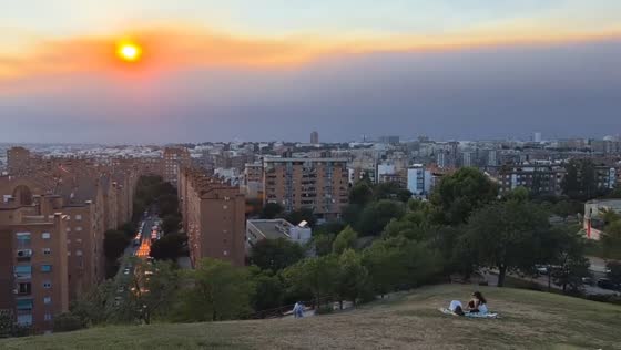 Wildfire smoke blankets Madrid skyline at sunset, Spain