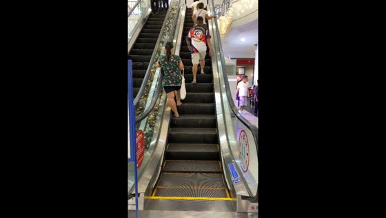 Person stands on stuck escalator in Robinsons Place Imus, Cavite