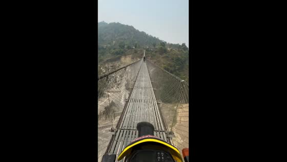Thrilling bike ride on a suspended Himalayan bridge