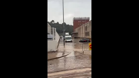 Torrential floodwaters sweep through streets and strand vehicles in Granollers, Spain