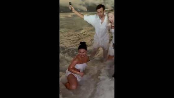 Unexpected wave causes stumble during New Year celebration in Rio de Janeiro, Brazil