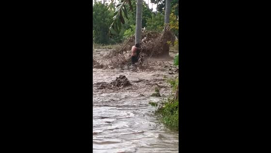 Man clings to tree during flash flood caused by creek overflow in Sarangani, Philippines