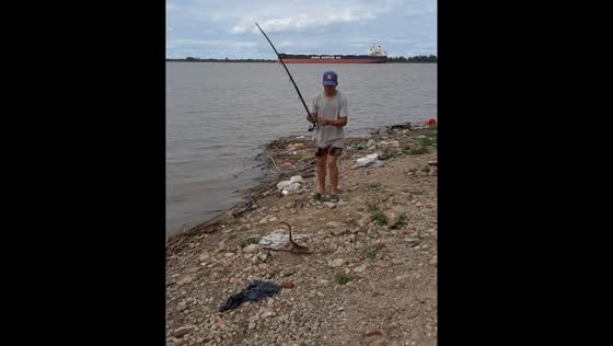 Fisherman catches iguana while fishing in Rosario, Argentina