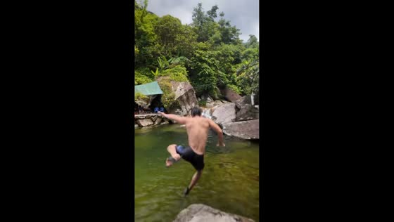 Man slips wearing large slippers while jumping into river in Philippines