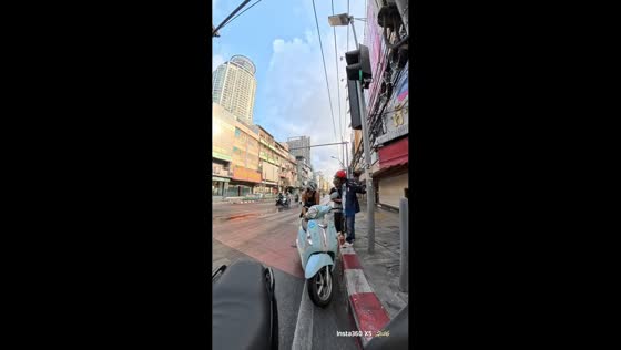 Elderly couple falls from scooter on slippery road in Bangkok, Thailand