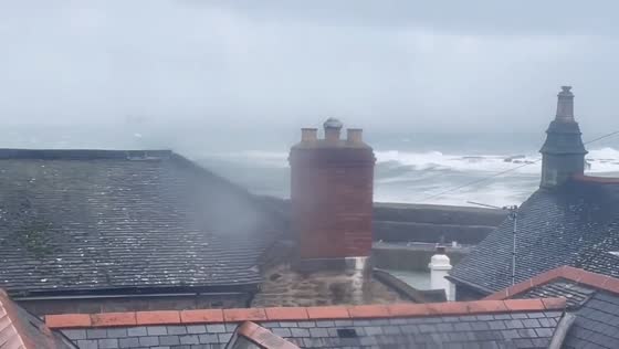 Massive waves batter Mousehole harbor during Storm Chandra in Mousehole, Cornwall, UK
