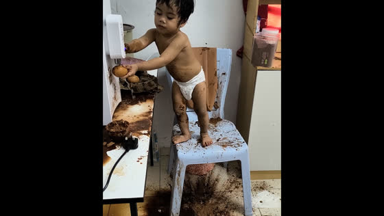 Toddler creates kitchen mess with egg and chocolate powder in Penang