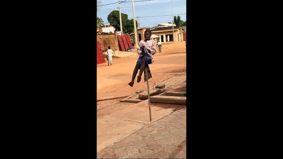 Young boy performs traditional stick dance in Parakou, Benin