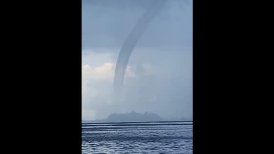 Huge waterspout near with the cruise ship Disney Fantasy on Caribbean islands