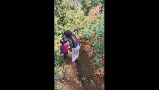 Girl slips off small embankment while family walks mountain trail in Bandung, Indonesia