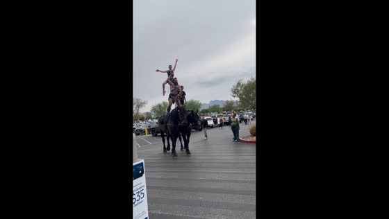 Performers balance atop two horses at Walmart in Las Vegas, USA