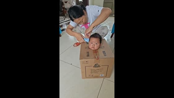 Toddler gets haircut inside a box in Jiangsu, China