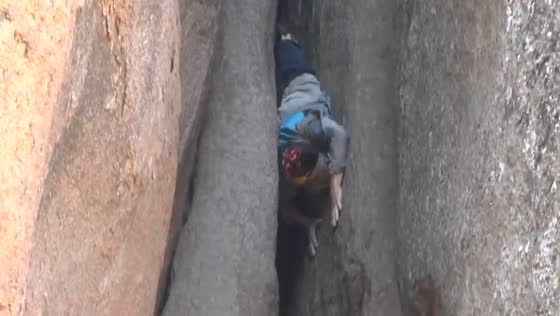 Elderly climber performs barefoot cliff descent at Stolby Reserve in Krasnoyarsk, Russia