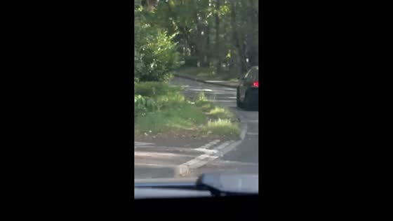 Car continues driving after tire detaches in Woking, England, UK