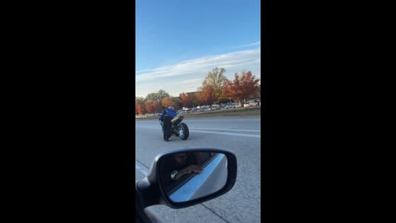 Motorcycle rider performs road trick in Greensboro, North Carolina, USA
