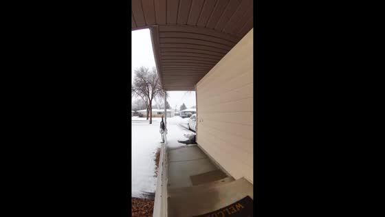Man falls after slipping on snow in Fargo, North Dakota, USA