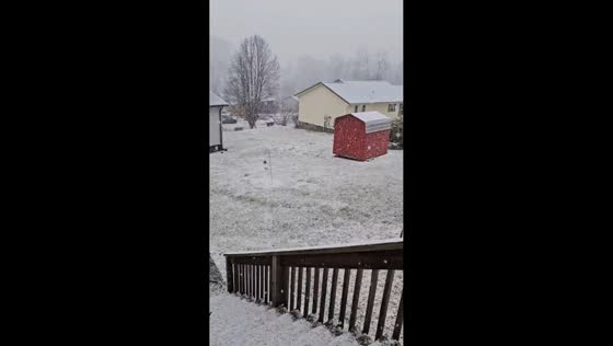 Heavy snowfall accumulates during cold afternoon in Harlan, Kentucky, USA