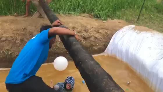 Participant falls into muddy hole during balloon game in Medan, Indonesia