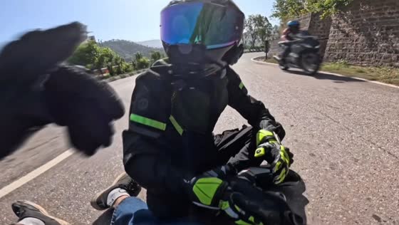 Motorbike slips on oily road during ride in Himachal Pradesh, India