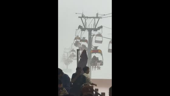Tourists caught in heavy rain and fog while riding sea cableway in Qinhuangdao, China