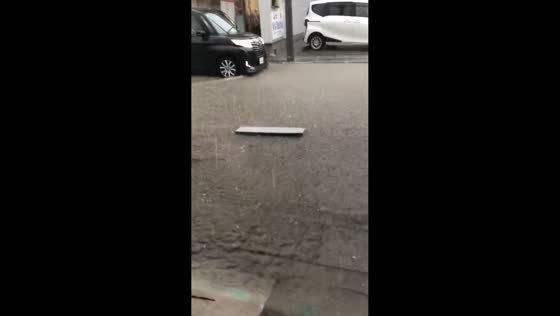Heavy rain causes shallow street flooding in Numata, Japan