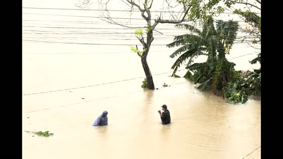 Residents navigate flooded fields after tropical storm Kristine hits Bicol
