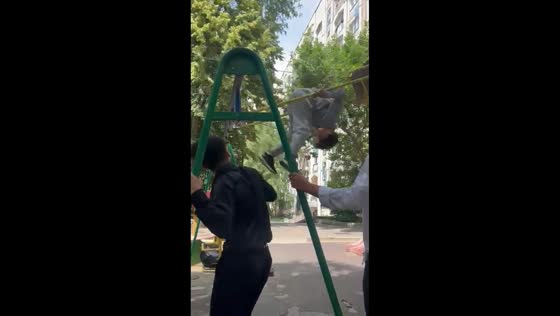 Boy spins midair on strong swing ride in Almaty, Kazakhstan