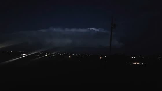 Thunderstorm illuminates clouds over town in Peyton, Colorado, USA