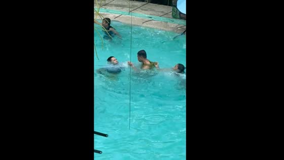 Slide into waters takes unexpected turn, friend's quick save prevents potential swim mishap